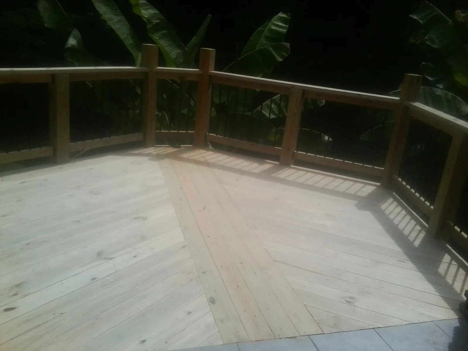 New wood deck and railing built off the back of a home in West Bend